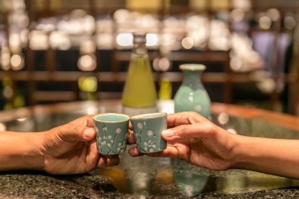 a couple drinking sake